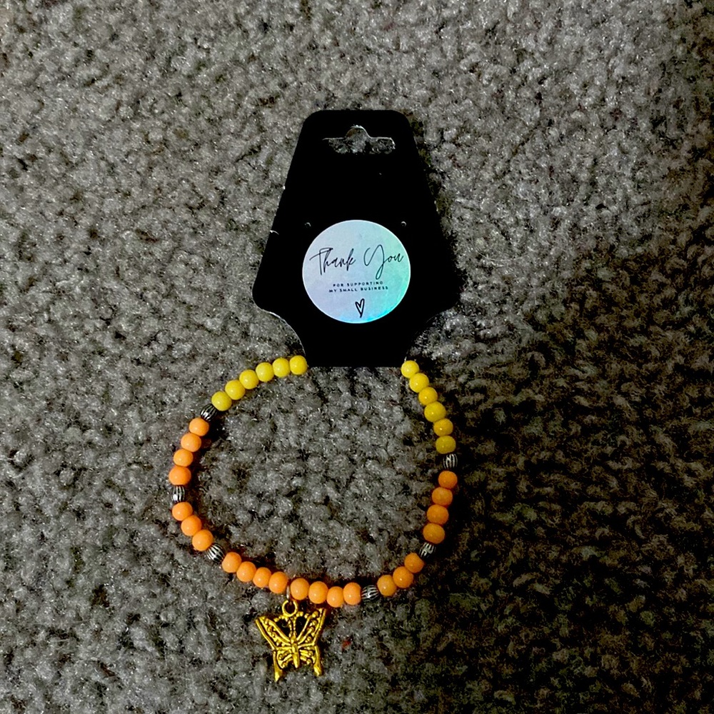 Handmade multi color bracelet with a butterfly charm